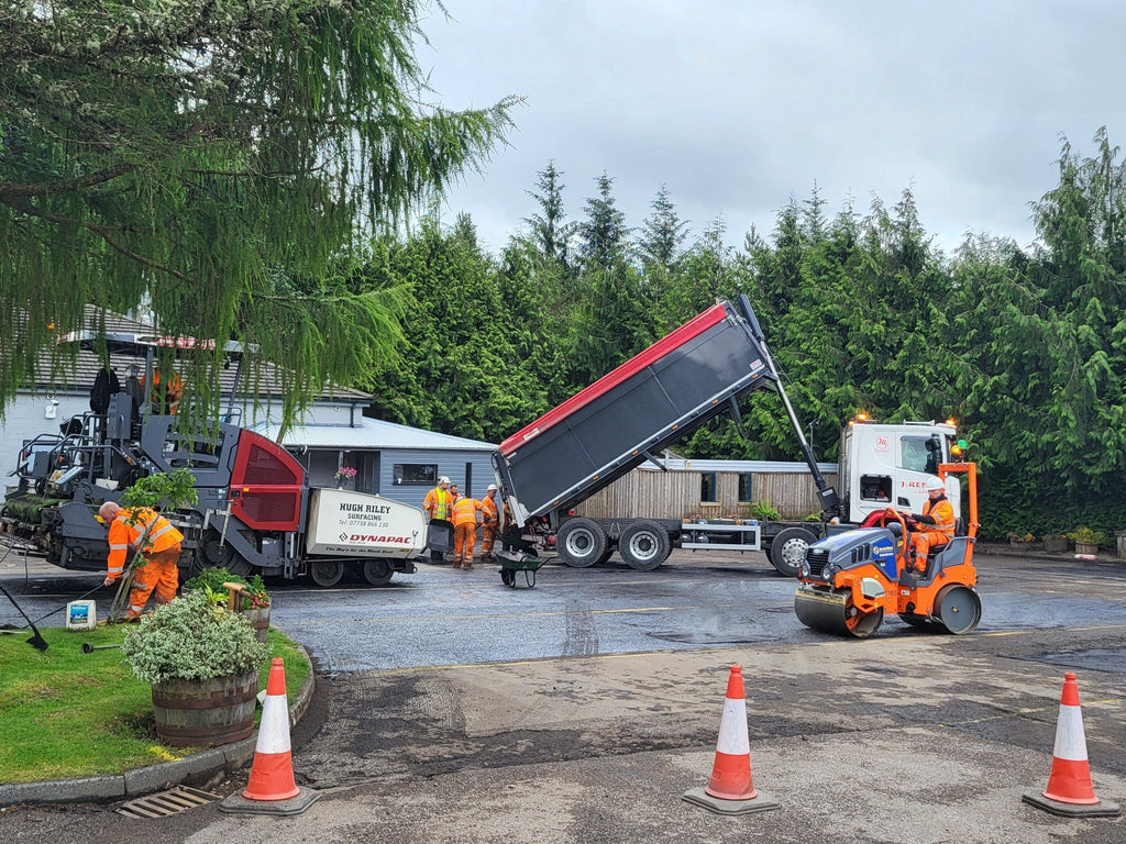 Heavy duty machinery resurfacing car park at The Real Food Cafe in Tyndrum