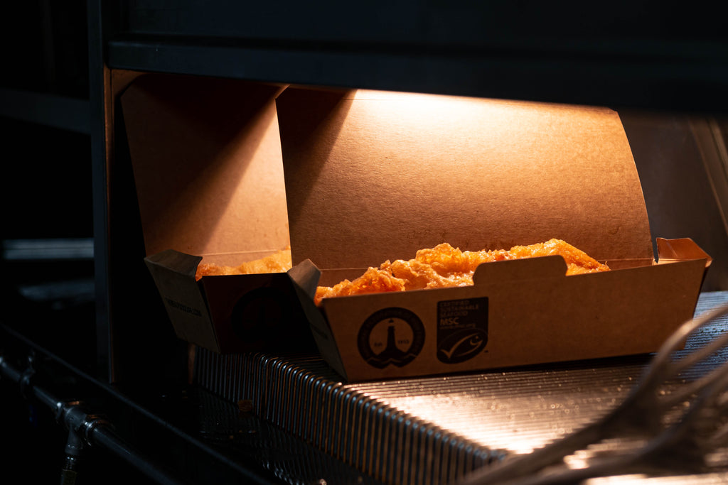 golden fried haddock in takeaway cardboard box with MSC and NFFF logo